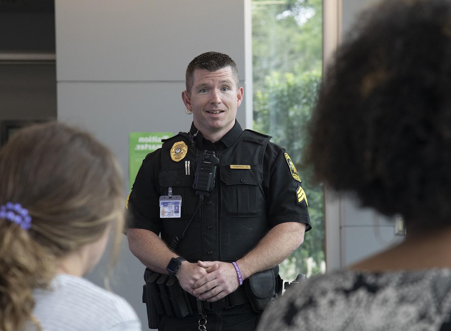 Officer conversing with students.